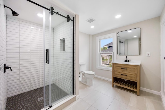 50 14th St, Bangor, ME 04401 - bathroom featuring vanity, toilet, a shower stall, baseboards, and tile patterned flooring