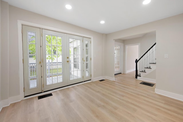 50 14th St, Bangor, ME 04401 - entryway featuring french doors, baseboards, stairway, wood finished floors, and recessed lighting