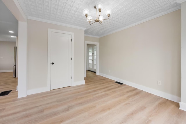 50 14th St, Bangor, ME 04401 - unfurnished dining area with an ornate ceiling, a chandelier, baseboards, crown molding, and light wood-style floors