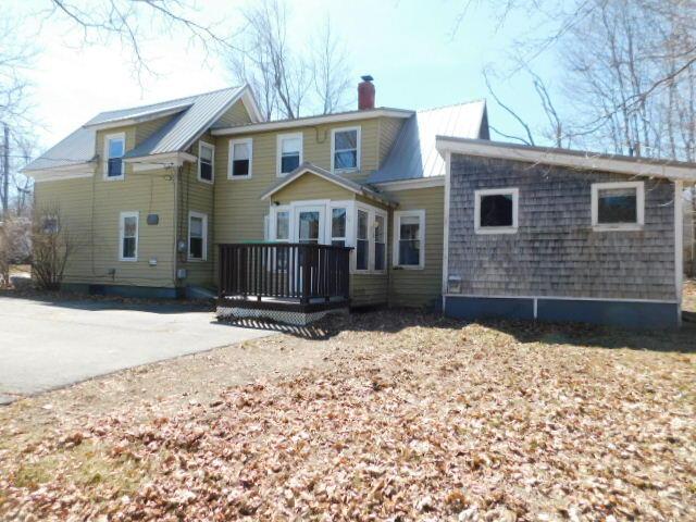 10 Summer St, Calais, ME 04619 - back of house with a chimney, a deck, and metal roof