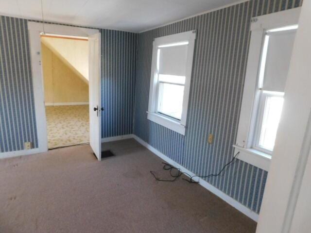 10 Summer St, Calais, ME 04619 - spare room featuring wallpapered walls, carpet floors, and healthy amount of natural light