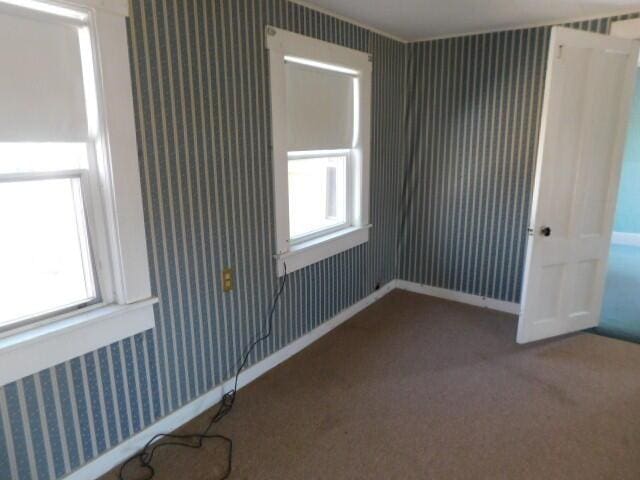 10 Summer St, Calais, ME 04619 - unfurnished room with wallpapered walls, plenty of natural light, and carpet