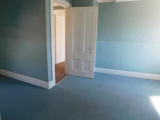 10 Summer St, Calais, ME 04619 - spare room featuring carpet floors, baseboards, and wallpapered walls