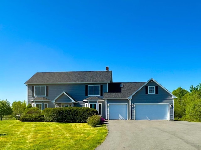 335 Western Ave, Hampden, ME 04444 - traditional home with asphalt driveway, a front lawn, a chimney, and a garage