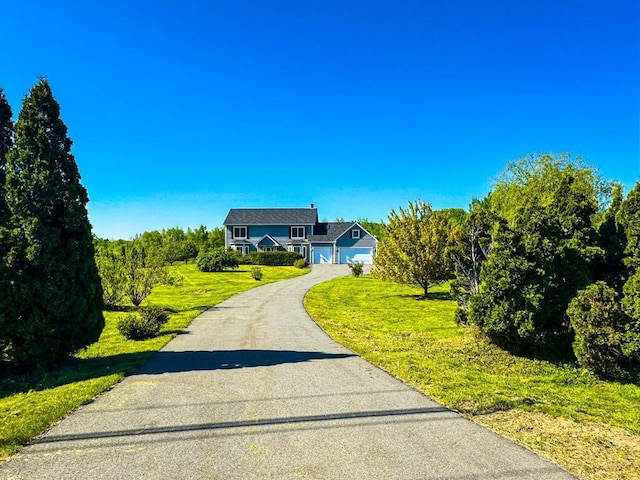 335 Western Ave, Hampden, ME 04444 - traditional home with driveway, a front lawn, and a garage