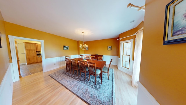 335 Western Ave, Hampden, ME 04444 - dining room featuring a chandelier, light wood finished floors, and a wainscoted wall