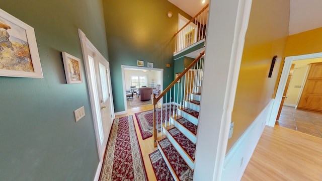 335 Western Ave, Hampden, ME 04444 - foyer with a towering ceiling, wood finished floors, stairs, and baseboards