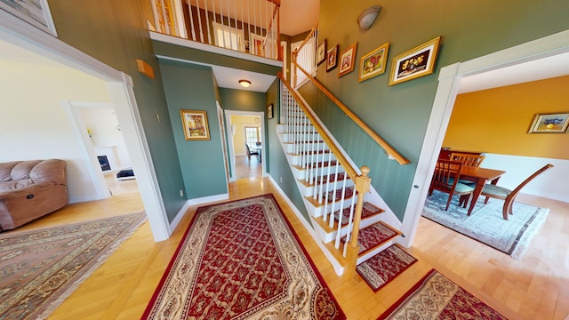 335 Western Ave, Hampden, ME 04444 - stairs with wood finished floors, a towering ceiling, and baseboards