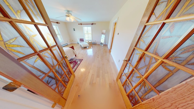 335 Western Ave, Hampden, ME 04444 - living area featuring ceiling fan, light wood finished floors, baseboards, and a baseboard heating unit