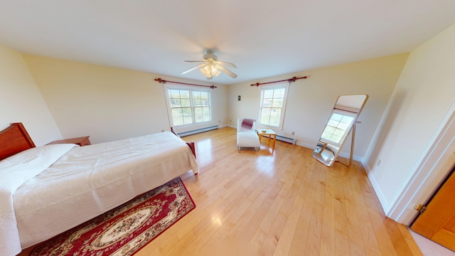335 Western Ave, Hampden, ME 04444 - bedroom with a baseboard heating unit, light wood-style flooring, a ceiling fan, and baseboards