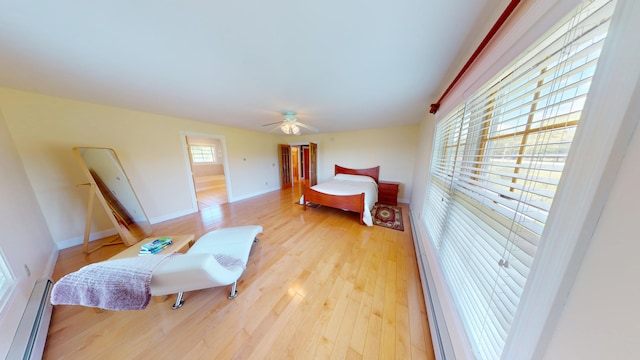 335 Western Ave, Hampden, ME 04444 - bedroom with a baseboard radiator, light wood-style flooring, baseboards, and a ceiling fan