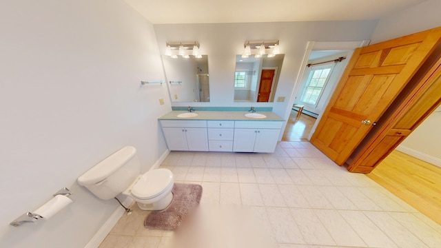335 Western Ave, Hampden, ME 04444 - bathroom with toilet, double vanity, baseboards, tile patterned floors, and a shower