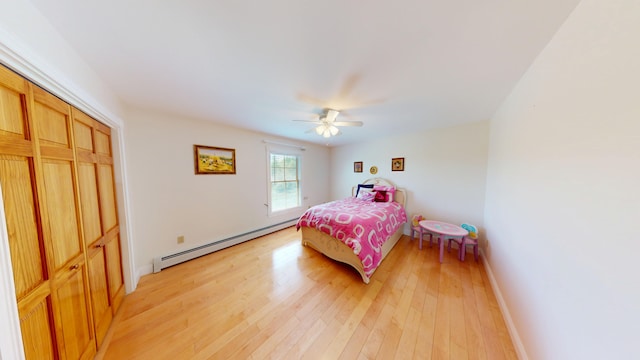 335 Western Ave, Hampden, ME 04444 - bedroom with a baseboard heating unit, light wood finished floors, baseboards, ceiling fan, and a closet
