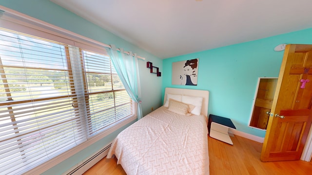335 Western Ave, Hampden, ME 04444 - bedroom with hardwood / wood-style flooring, baseboards, and a baseboard heating unit