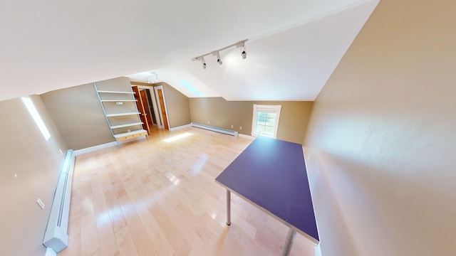335 Western Ave, Hampden, ME 04444 - additional living space with a baseboard heating unit, vaulted ceiling, light wood-type flooring, a baseboard radiator, and baseboards