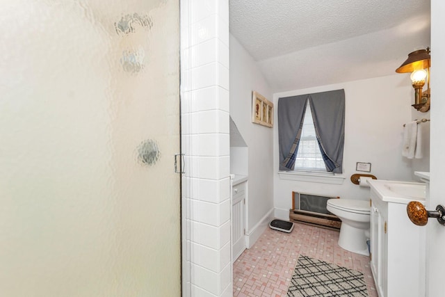 7 Acorn Cir Unit 7, Kennebunk, ME 04043 - bathroom with a shower stall, toilet, vanity, a textured ceiling, and baseboards