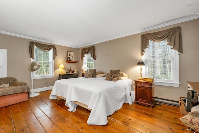 7 Acorn Cir Unit 7, Kennebunk, ME 04043 - bedroom featuring wood-type flooring, ornamental molding, a baseboard radiator, and baseboards