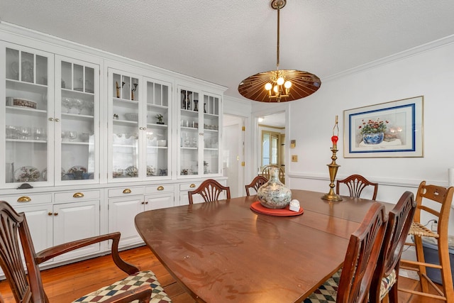 7 Acorn Cir Unit 7, Kennebunk, ME 04043 - dining space featuring a textured ceiling, light wood-style flooring, and ornamental molding