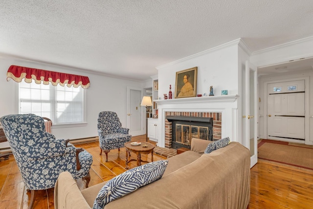 7 Acorn Cir Unit 7, Kennebunk, ME 04043 - living area featuring hardwood / wood-style flooring, a brick fireplace, crown molding, a textured ceiling, and baseboard heating