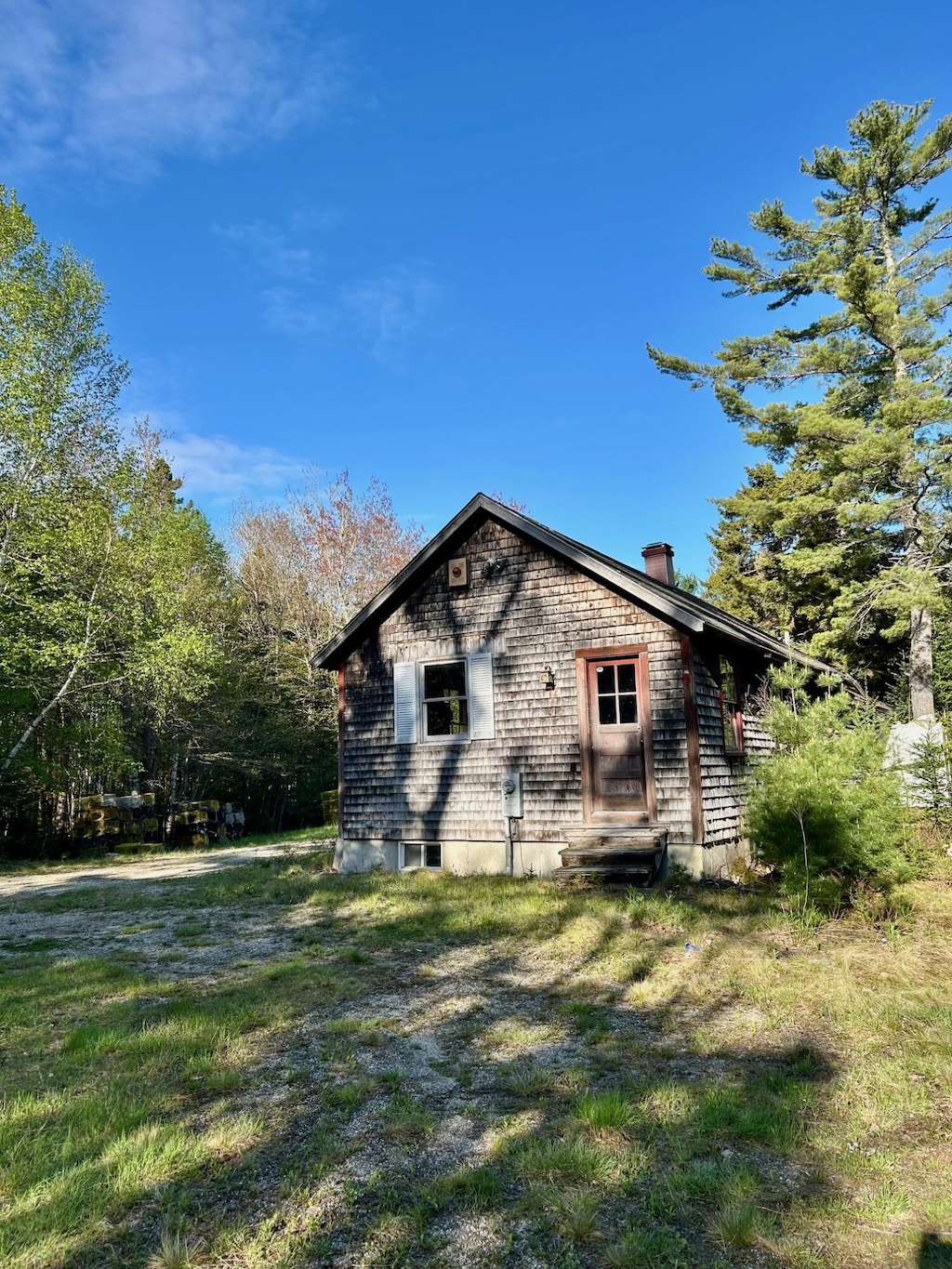 1189 Morgan Bay Rd, Blue Hill, ME 04614 - view of home's exterior with a chimney and a yard