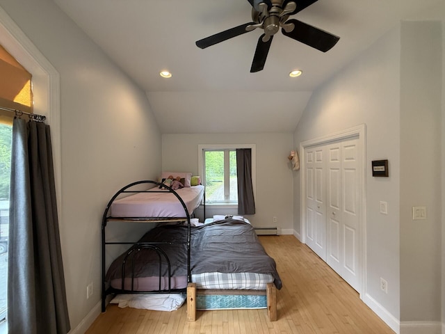 20 Lady Jennifer Dr, Biddeford, ME 04005 - bedroom featuring light wood finished floors, a baseboard radiator, vaulted ceiling, baseboards, and recessed lighting