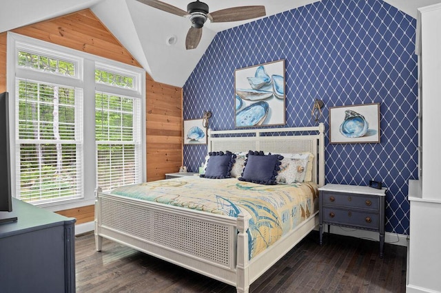 14 Winter Hills Ln, Ogunquit, ME 03907 - bedroom featuring lofted ceiling, an accent wall, dark wood-style flooring, wood walls, and ceiling fan