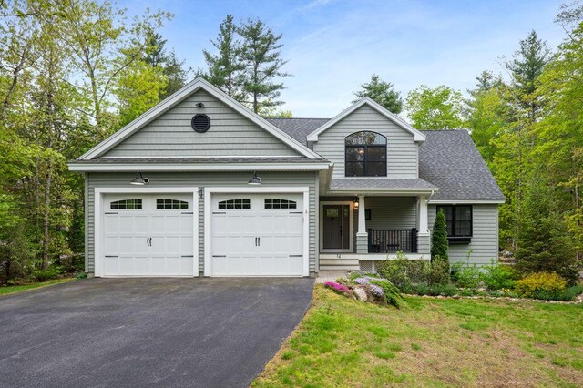 14 Winter Hills Ln, Ogunquit, ME 03907 - view of front of home with a porch, driveway, an attached garage, roof with shingles, and a front yard