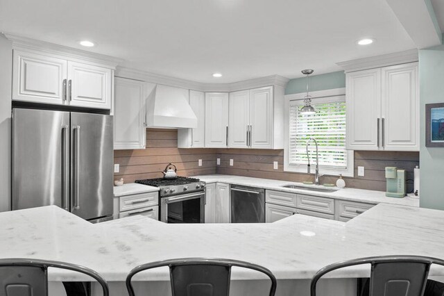 14 Winter Hills Ln, Ogunquit, ME 03907 - kitchen featuring premium appliances, custom exhaust hood, a sink, white cabinetry, and recessed lighting