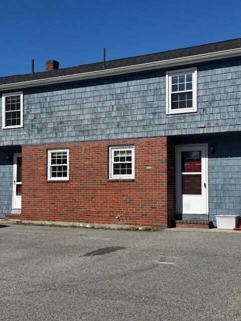 8 Sunset View St Unit 2, Gray, ME 04039 - view of property exterior with brick siding and a chimney