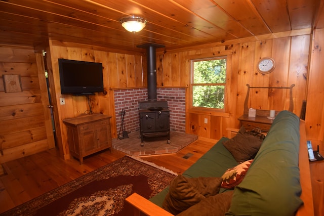 1809 Embden Pond Rd, Embden, ME 04958 - living area featuring wood walls, hardwood / wood-style flooring, a wood stove, and wooden ceiling