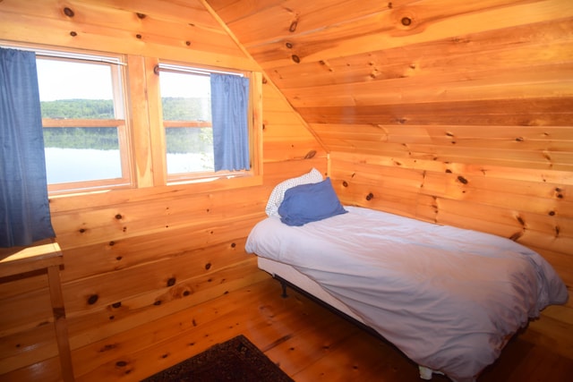 1809 Embden Pond Rd, Embden, ME 04958 - bedroom with wooden walls, vaulted ceiling, hardwood / wood-style floors, and wooden ceiling