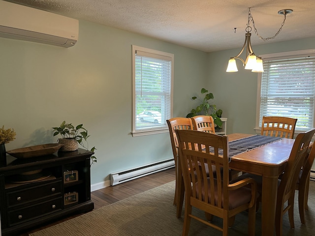 39 Thompson St, Wells, ME 04090 - dining room with a baseboard radiator, a wall mounted AC, wood finished floors, and a chandelier