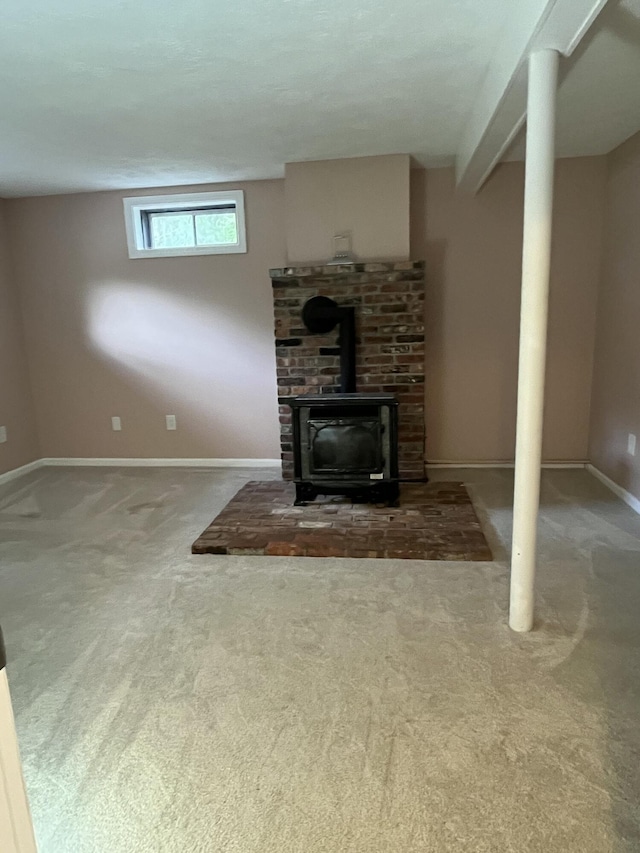 39 Thompson St, Wells, ME 04090 - unfurnished living room with carpet and a wood stove
