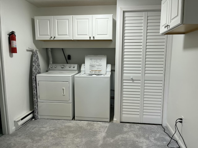 39 Thompson St, Wells, ME 04090 - washroom with cabinet space, baseboard heating, washing machine and clothes dryer, and light carpet