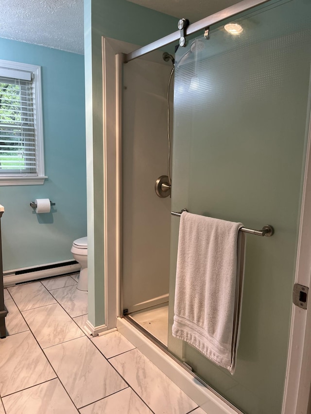 39 Thompson St, Wells, ME 04090 - bathroom with baseboard heating, marble finish floors, a shower stall, and a textured ceiling