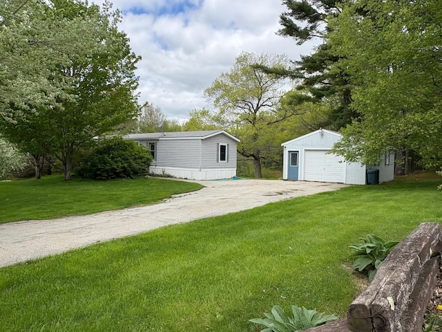 1236 Waldo Station Rd, Waldo, ME 04915 - view of grassy yard with a detached garage, an outbuilding, and driveway