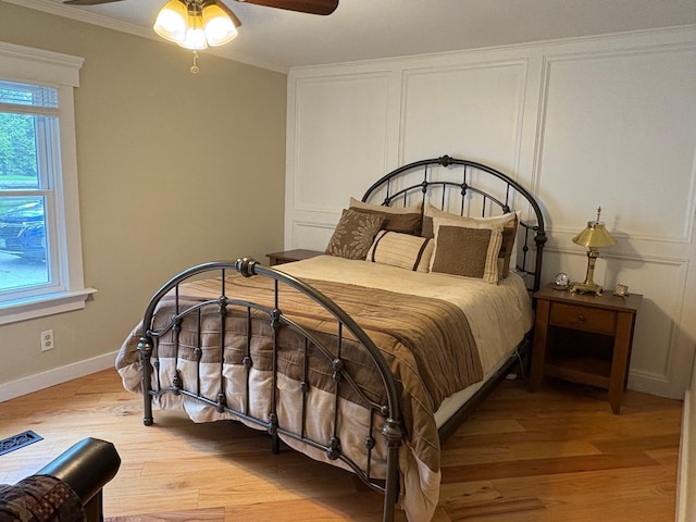 1236 Waldo Station Rd, Waldo, ME 04915 - bedroom featuring light wood-type flooring, multiple windows, ornamental molding, baseboards, and ceiling fan