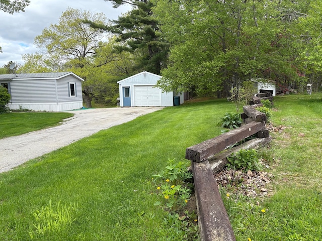 1236 Waldo Station Rd, Waldo, ME 04915 - view of grassy yard featuring an outdoor structure, a detached garage, and driveway
