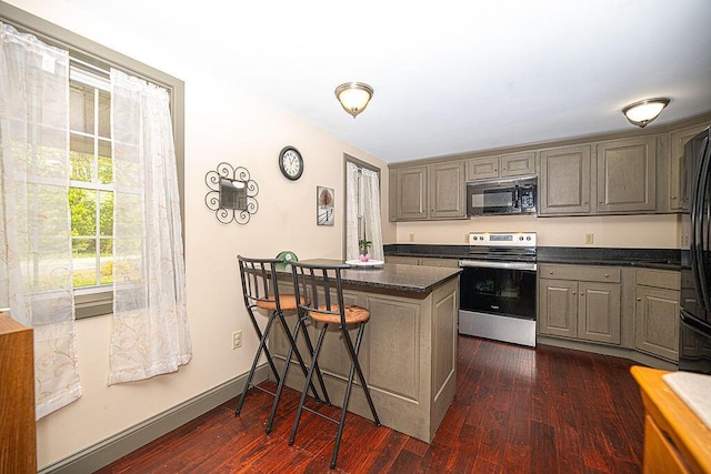 84 Little River Rd, Berwick, ME 03901 - kitchen with electric stove, a kitchen breakfast bar, dark wood-style floors, gray cabinetry, and baseboards