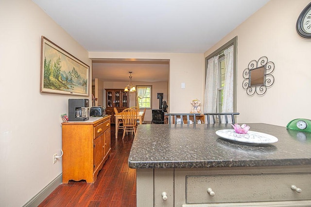 84 Little River Rd, Berwick, ME 03901 - kitchen with dark wood finished floors, dark countertops, a chandelier, baseboards, and brown cabinetry