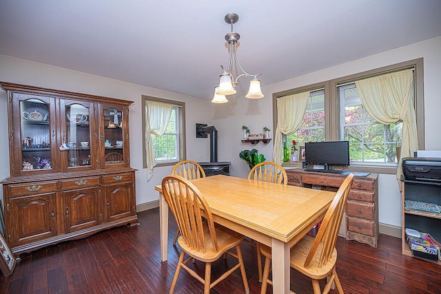 84 Little River Rd, Berwick, ME 03901 - dining space featuring dark wood-type flooring, a wood stove, and baseboards