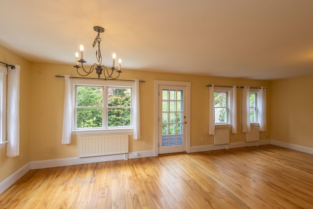 17 Spruce St, Rockport, ME 04856 - spare room with radiator, a chandelier, hardwood / wood-style floors, and plenty of natural light