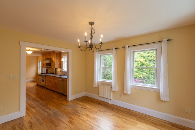 17 Spruce St, Rockport, ME 04856 - spare room with radiator, a sink, a chandelier, light wood-style flooring, and baseboards