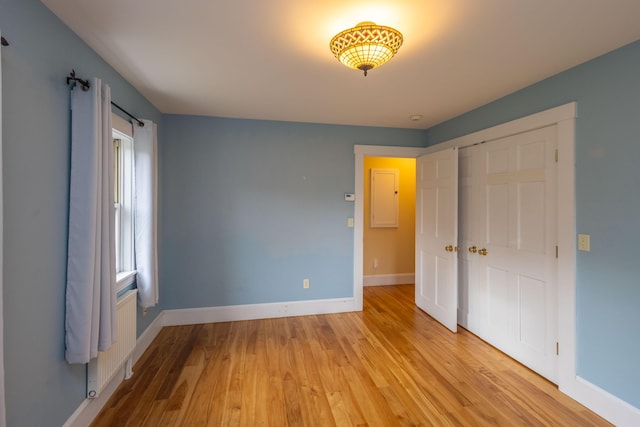 17 Spruce St, Rockport, ME 04856 - unfurnished bedroom featuring light wood finished floors, baseboards, and a closet