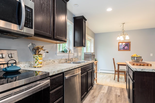 80 Hubbard Rd, Berwick, ME 03901 - kitchen featuring stainless steel appliances, a sink, light countertops, light wood-style flooring, and a chandelier