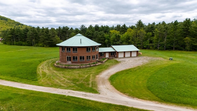 2222 Main Rd, Chatham, NH 03813 - view of front facade featuring a wooded view, driveway, a front lawn, an attached garage, and metal roof