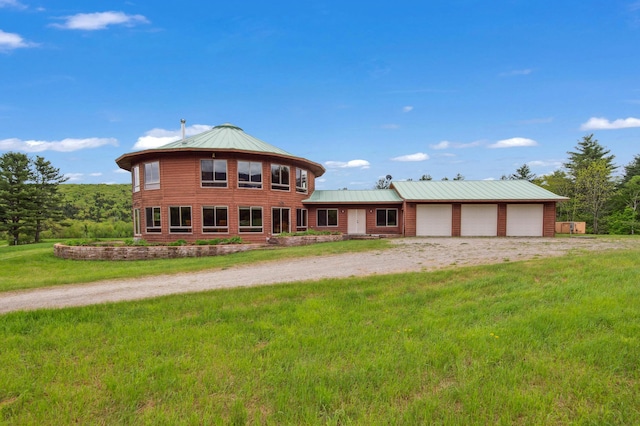 2222 Main Rd, Chatham, NH 03813 - view of front facade with driveway, a front lawn, a garage, and metal roof