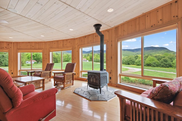 2222 Main Rd, Chatham, NH 03813 - living area with a wood stove, a mountain view, wood ceiling, wooden walls, and recessed lighting