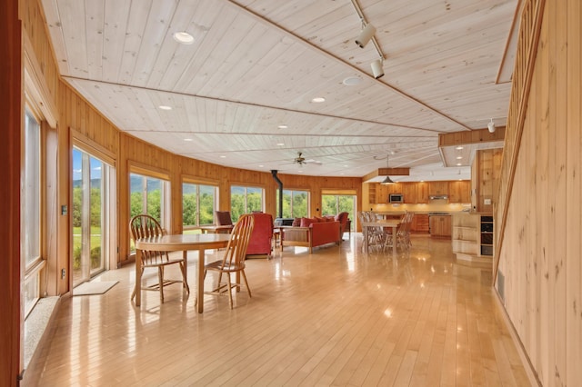 2222 Main Rd, Chatham, NH 03813 - dining area with wooden ceiling, wooden walls, light wood finished floors, a ceiling fan, and rail lighting