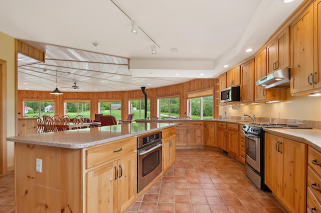 2222 Main Rd, Chatham, NH 03813 - kitchen with appliances with stainless steel finishes, under cabinet range hood, healthy amount of natural light, a kitchen island, and recessed lighting